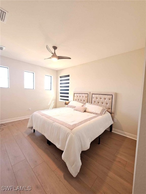 bedroom with wood-type flooring and ceiling fan