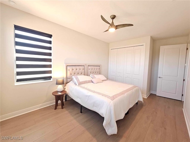 bedroom with light hardwood / wood-style flooring, a closet, and ceiling fan