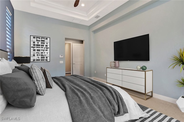 carpeted bedroom featuring crown molding, ceiling fan, and a raised ceiling