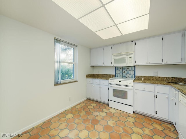 1940A Bald Eagle Dr, Naples, FL 34105 - kitchen with a sink, white appliances, baseboards, and white cabinets