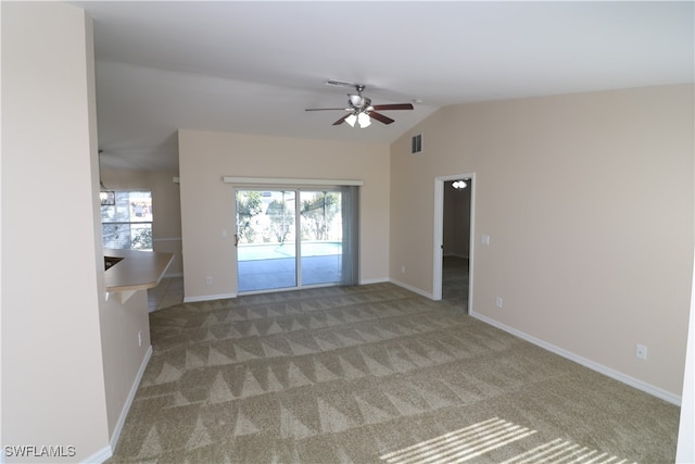 carpeted empty room with ceiling fan and vaulted ceiling