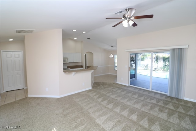 unfurnished living room featuring light colored carpet and ceiling fan