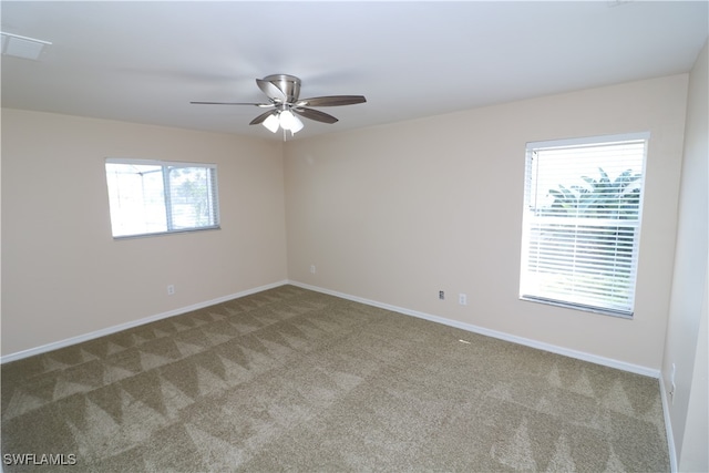 spare room with carpet floors and ceiling fan