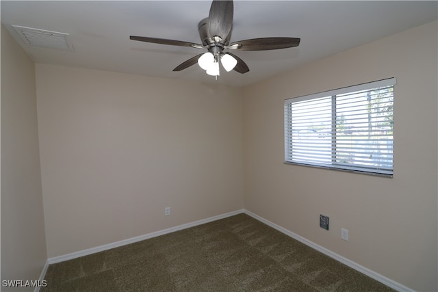 unfurnished room featuring dark colored carpet and ceiling fan