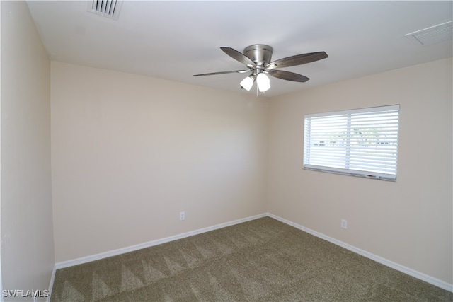 empty room with ceiling fan and carpet flooring