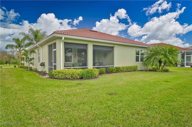 view of property exterior with a lawn and a sunroom