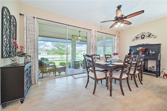 tiled dining area with a wealth of natural light and ceiling fan