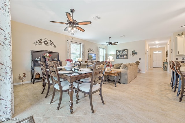 tiled dining area with ceiling fan