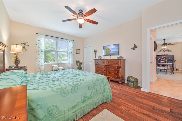 bedroom with hardwood / wood-style floors and ceiling fan