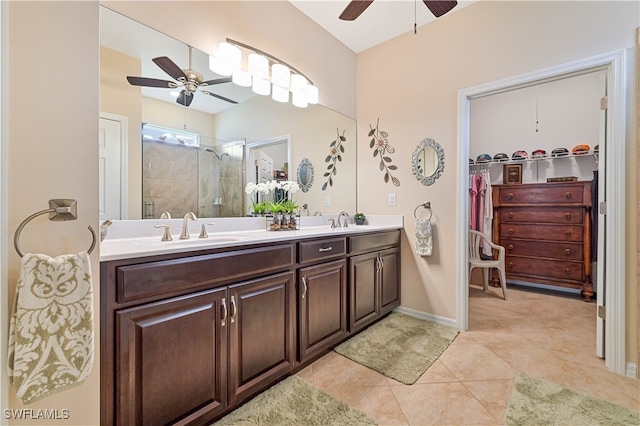 bathroom with ceiling fan, walk in shower, tile patterned flooring, and vanity