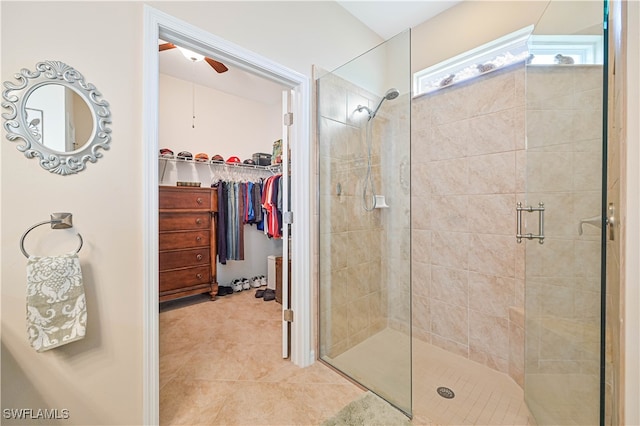 bathroom with walk in shower, ceiling fan, and tile patterned floors