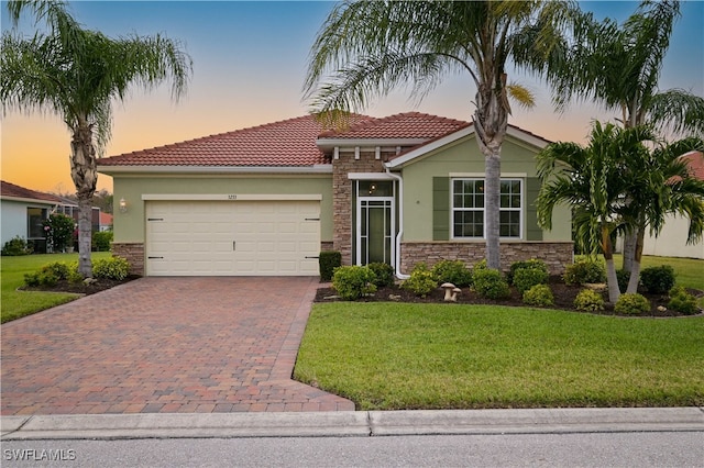 view of front facade featuring a garage and a yard