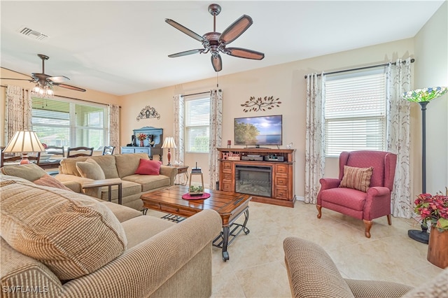 tiled living room with ceiling fan