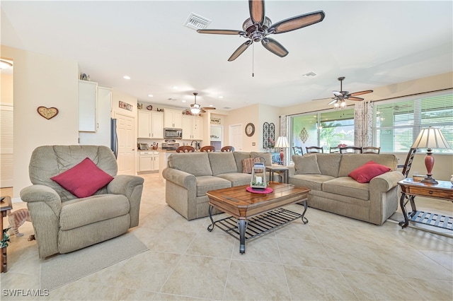 living room featuring ceiling fan and light tile patterned floors