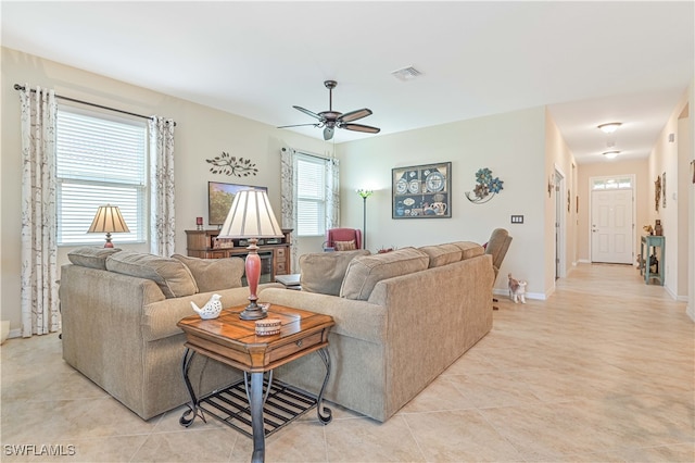 tiled living room with ceiling fan