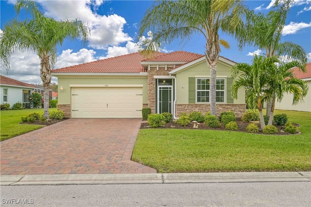 mediterranean / spanish-style house featuring a garage and a front lawn