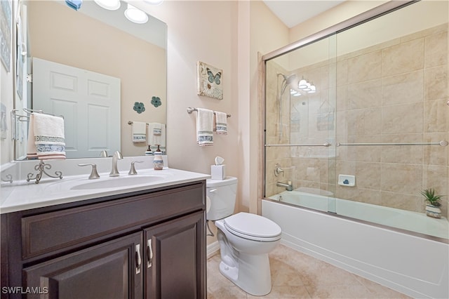 full bathroom featuring tile patterned flooring, enclosed tub / shower combo, toilet, and vanity