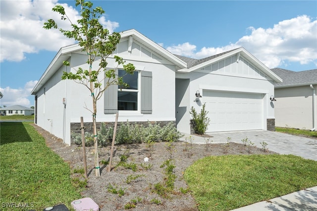 view of front of property featuring a garage and a front yard