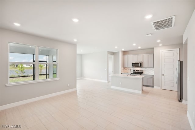 unfurnished living room with sink