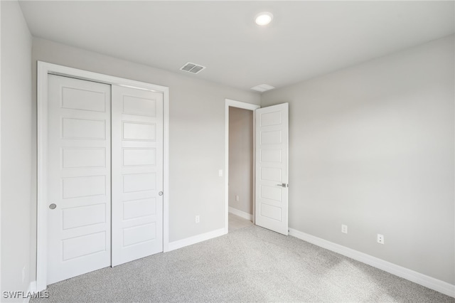 unfurnished bedroom featuring a closet and carpet floors