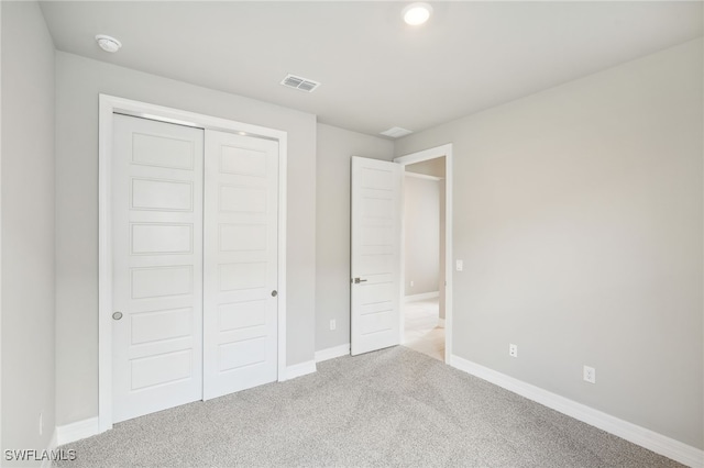 unfurnished bedroom with carpet floors and a closet