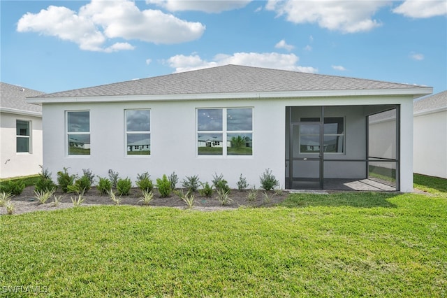 back of property with a sunroom and a yard