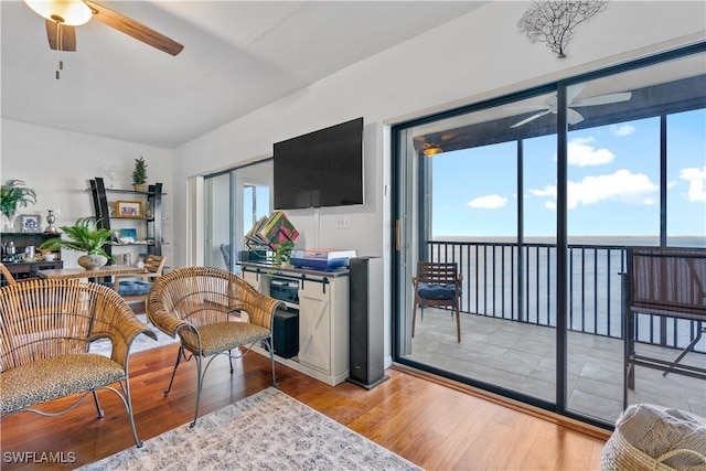 living room with light wood-type flooring and ceiling fan