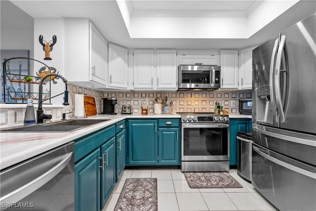 kitchen with appliances with stainless steel finishes, blue cabinetry, and white cabinets