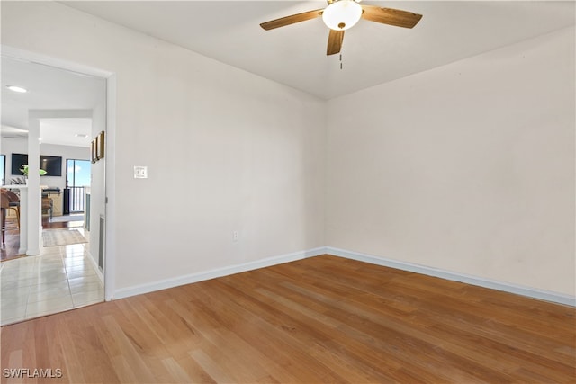 unfurnished room featuring ceiling fan and hardwood / wood-style flooring