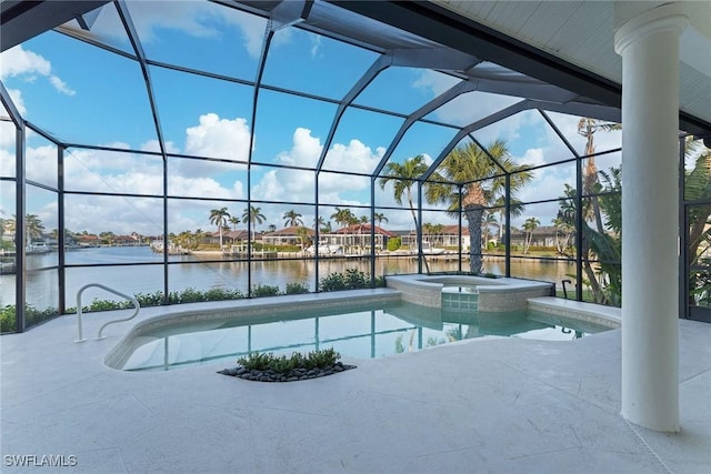 view of pool with glass enclosure, a patio area, an in ground hot tub, and a water view