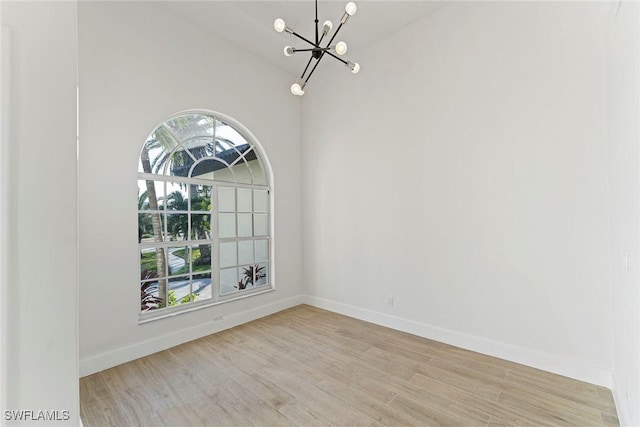 unfurnished dining area with a chandelier and light hardwood / wood-style flooring