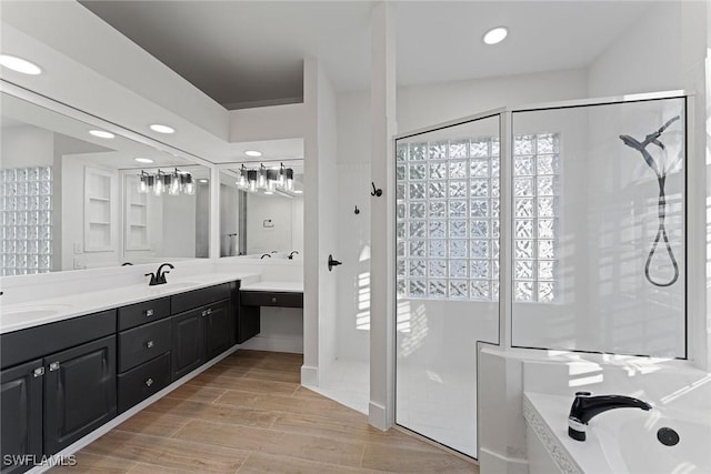 bathroom featuring vanity, a healthy amount of sunlight, and separate shower and tub