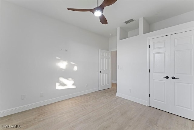 unfurnished bedroom with a closet, ceiling fan, and light wood-type flooring