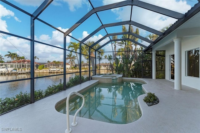 view of pool featuring glass enclosure, a patio, a water view, and a pool with connected hot tub