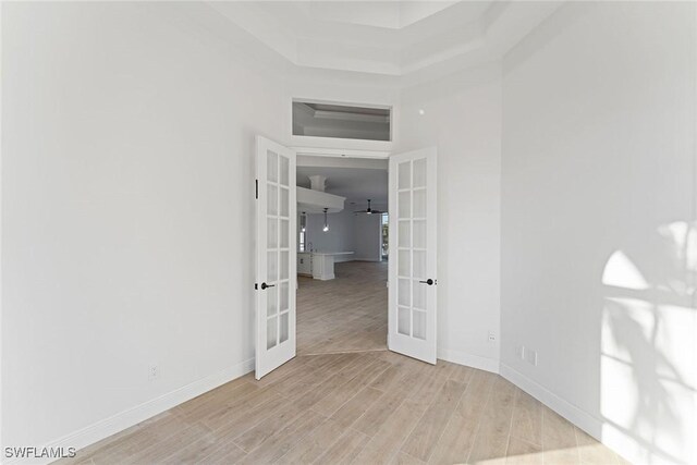 spare room featuring light hardwood / wood-style floors and french doors