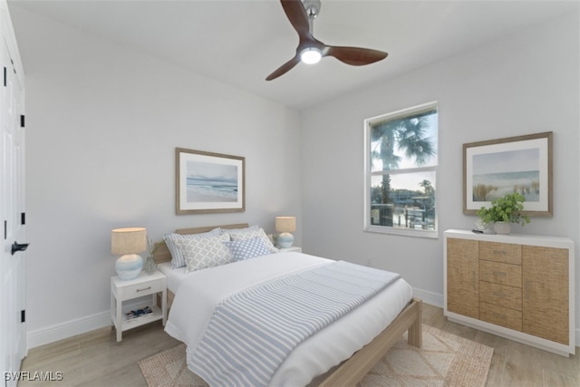 bedroom with light hardwood / wood-style floors and ceiling fan