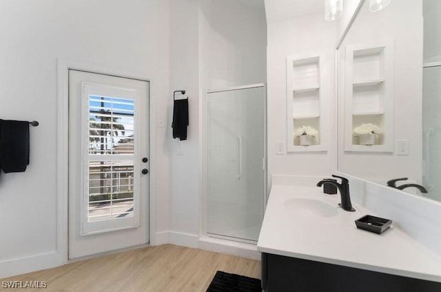 full bath featuring a shower stall, vanity, and wood finished floors