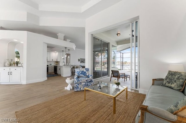 living room with light wood-style flooring and baseboards