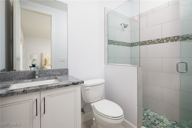 bathroom featuring vanity, toilet, and walk in shower