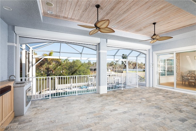 unfurnished sunroom with sink and wooden ceiling