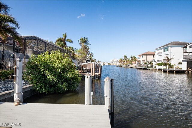 view of dock with a water view and a lanai