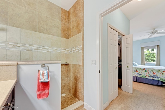 bathroom with ceiling fan, a tile shower, and vanity