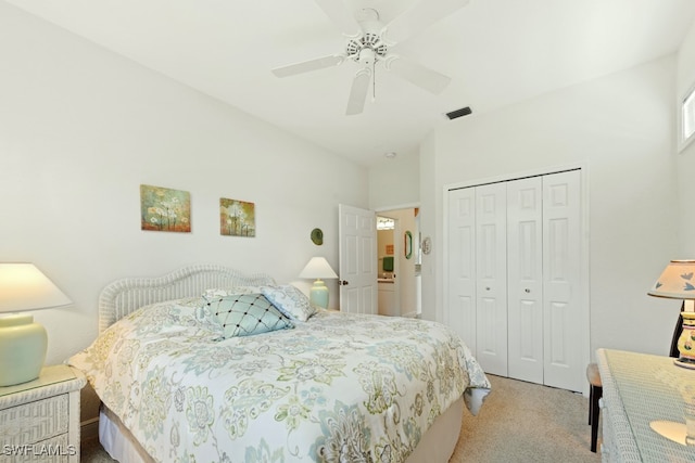 bedroom with ceiling fan, vaulted ceiling, light colored carpet, and a closet