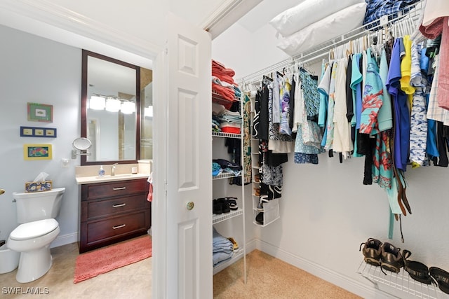 walk in closet featuring sink