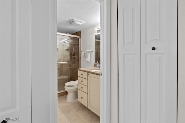 bathroom featuring an enclosed shower, vanity, a textured ceiling, and toilet