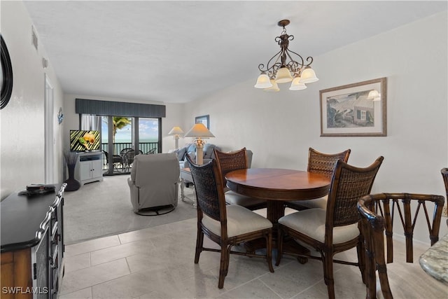 7500 Estero Blvd Unit 203, Fort Myers Beach, FL 33931 - dining room with a chandelier and light tile patterned floors