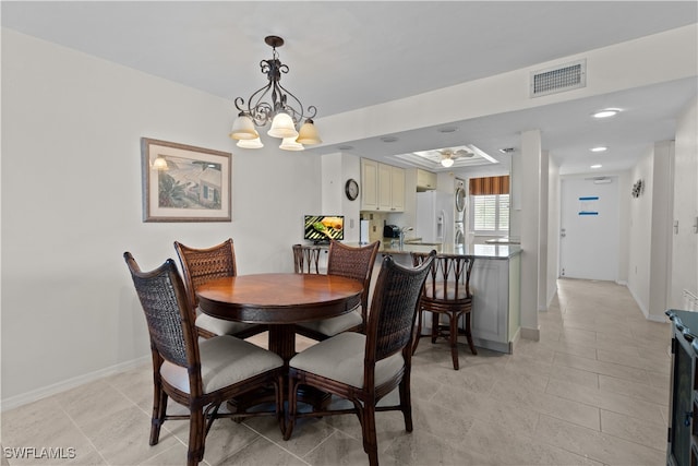 dining area with light tile patterned floors and an inviting chandelier