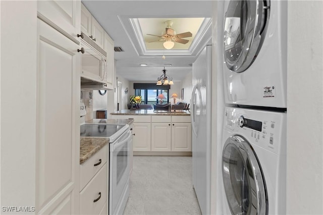 7500 Estero Blvd Unit 203, Fort Myers Beach, FL 33931 - laundry area with stacked washing machine and dryer, ceiling fan, a skylight, and a chandelier