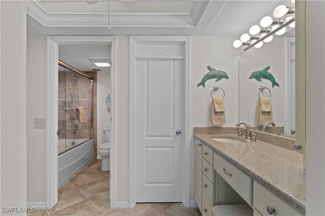 full bathroom with tile patterned flooring, enclosed tub / shower combo, vanity, crown molding, and toilet