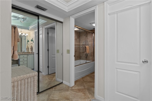 bathroom with tile patterned floors, ornamental molding, enclosed tub / shower combo, vanity, and ceiling fan